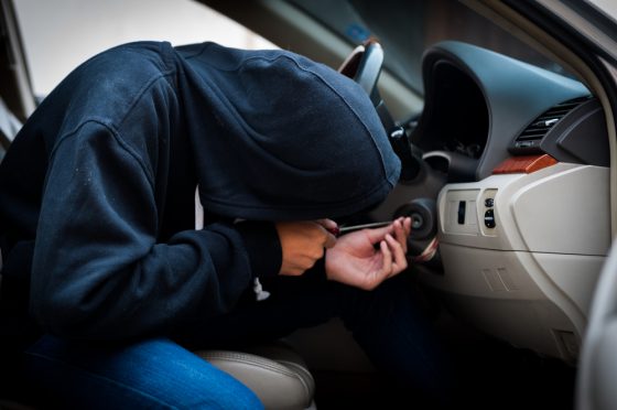 Thief forcing the keys in the car - Cost-U-Less - cheap auto insurance in California