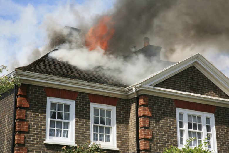 A home is on fire on the roof - cheap homeowners insurance in California.