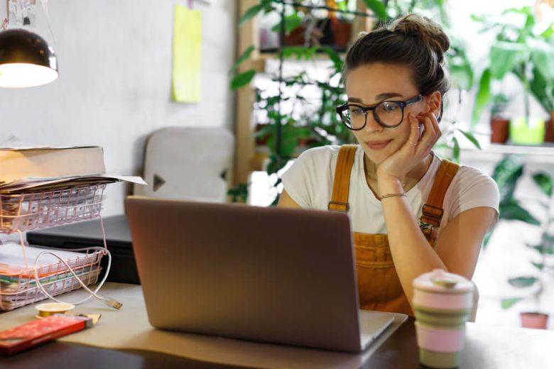 Woman wearing glasses on computer.