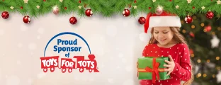 Girl in a Santa hat holding a gift with 'Proud Sponsor of Toys for Tots' logo and Christmas decorations.